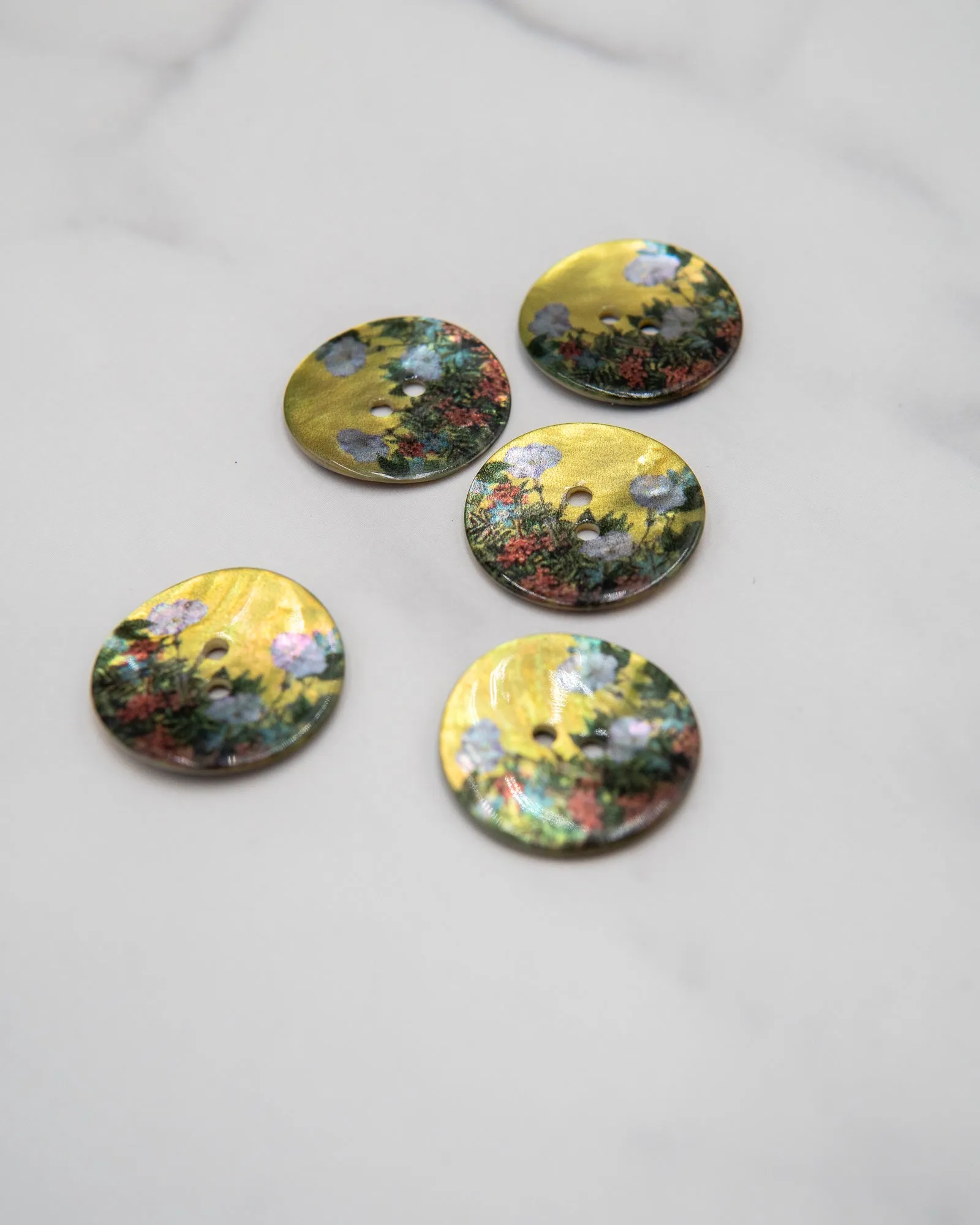 Glossy shell buttons with flowers on yellow background - 23 mm or 9/10"