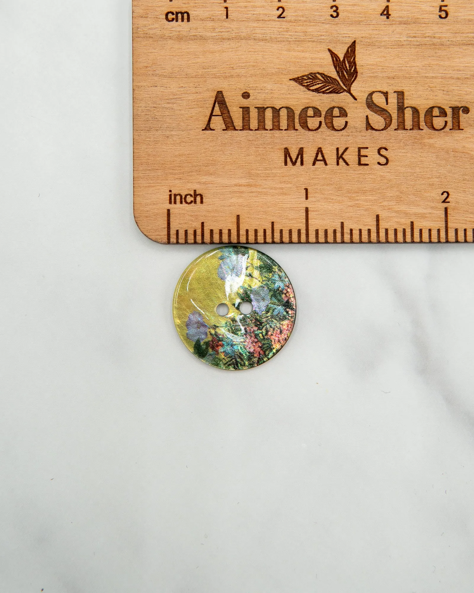Glossy shell buttons with flowers on yellow background - 23 mm or 9/10"